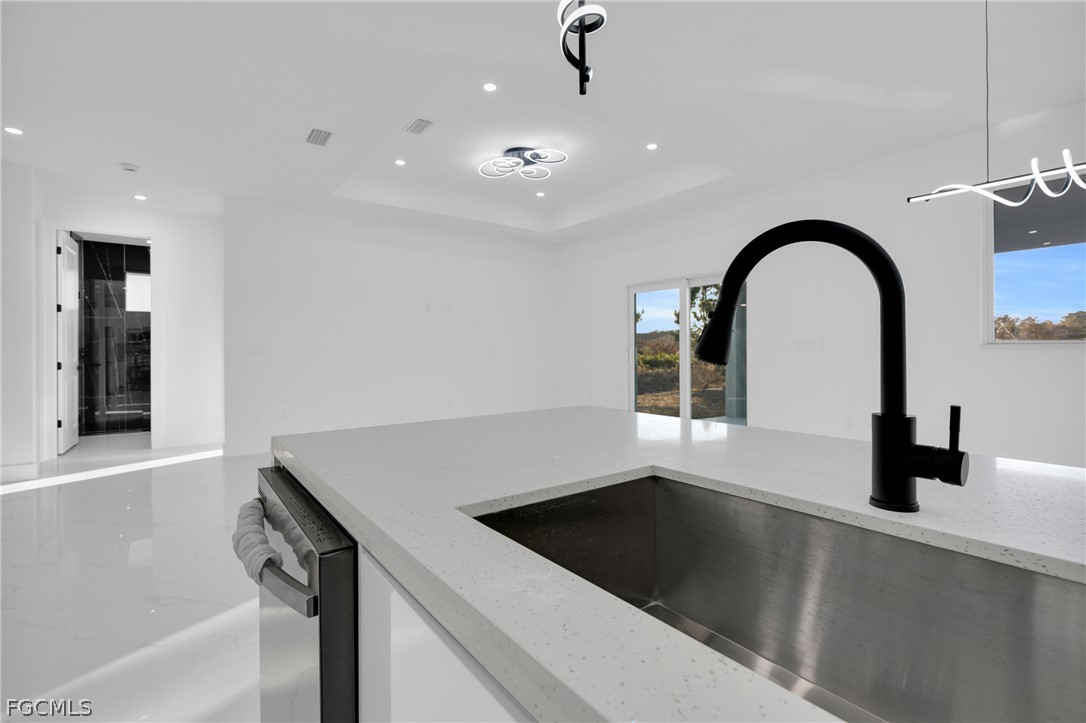 1819 Rush Avenue Lehigh Acres, FL 33972 - Photo 14 of 40 a view of a sink and dishwasher with wooden floor