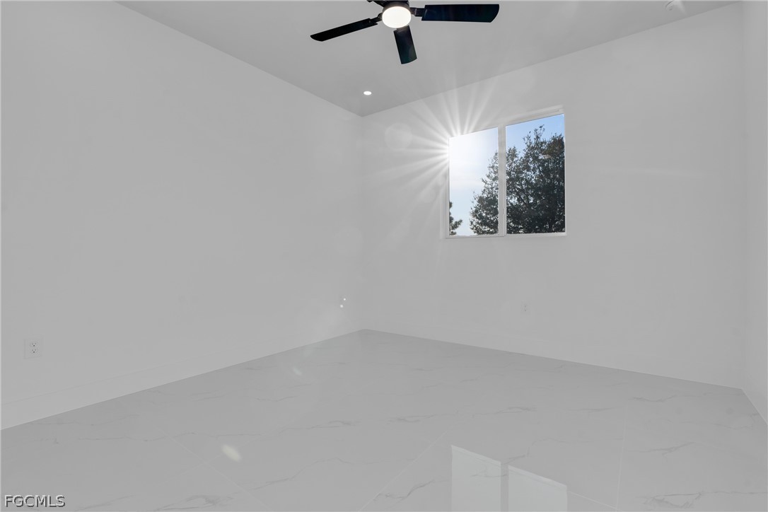 1819 Rush Avenue Lehigh Acres, FL 33972 - Photo 20 of 40 an empty room with a ceiling fan and window