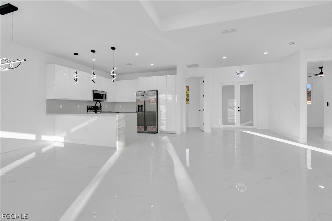 1819 Rush Avenue Lehigh Acres, FL 33972 - Photo 4 of 40 a view of a kitchen with a sink and a refrigerator