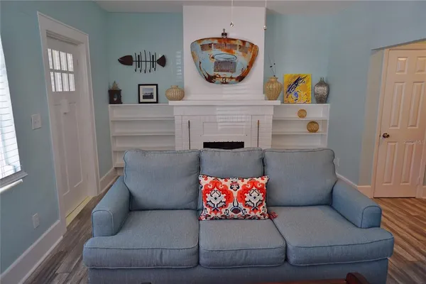 a living room with furniture and a painting on the wall