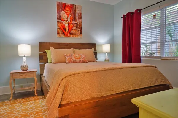 a bedroom with a bed and a lamp with window