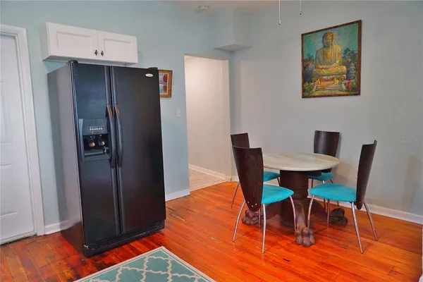 a dining room with furniture and wooden floor