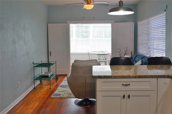 a living room with kitchen island furniture and a wooden floor