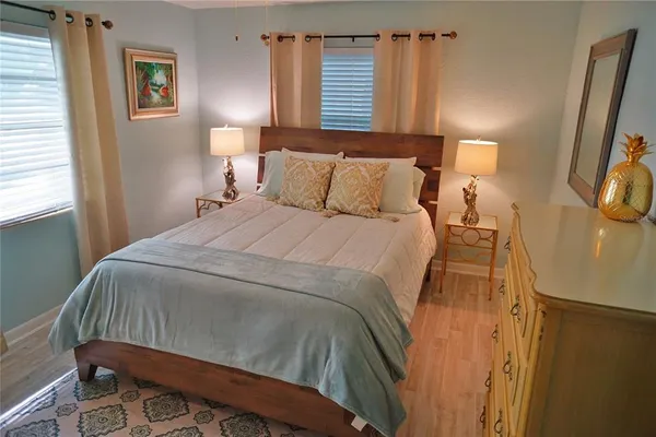 a bed sitting in a bedroom next to a window