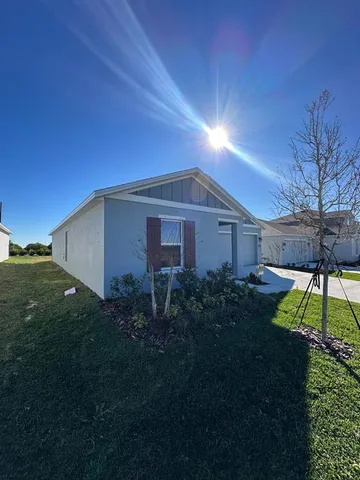 a view of a backyard with plants and a garden