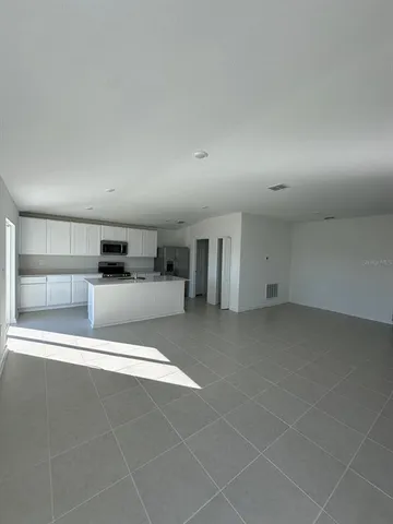 a view of a kitchen with a sink and a refrigerator