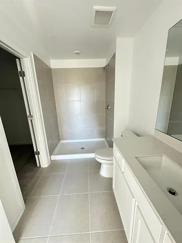 a bathroom with a tub a toilet a sink and a shower