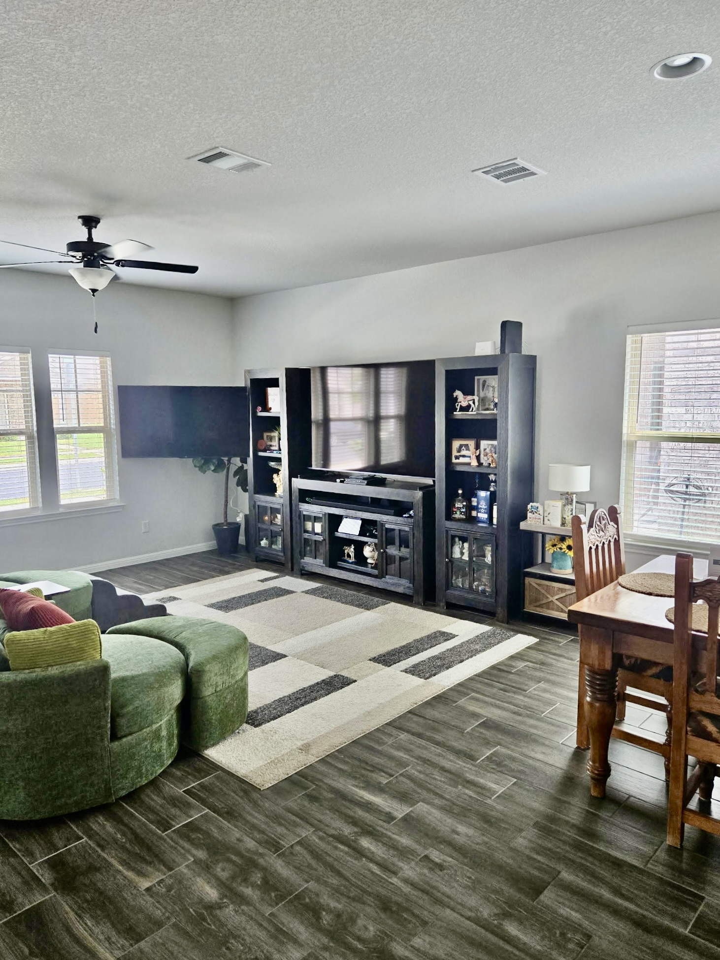 140 Pentro Path Georgetown, TX 78626 - Photo 6 of 37 An inviting open-concept area features durable wood-look tile flooring and recessed lighting.