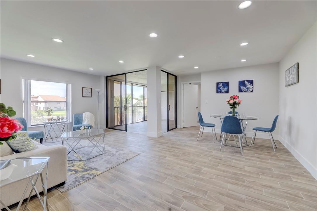 8577 Boca Glades Boulevard, Unit H Boca Raton, FL 33434 - Photo 1 of 34 a living room with furniture and wooden floor
