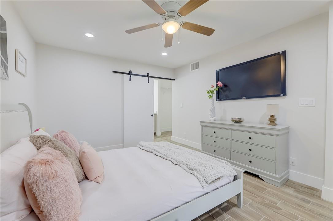 8577 Boca Glades Boulevard, Unit H Boca Raton, FL 33434 - Photo 14 of 34 a bedroom with a bed and a flat screen tv