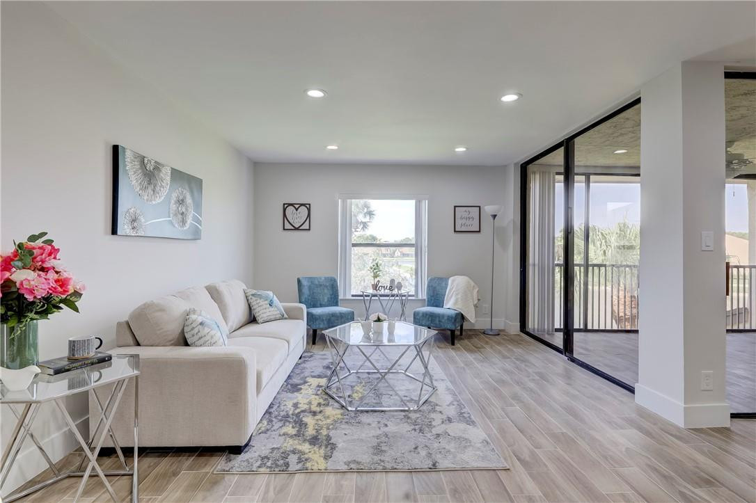 8577 Boca Glades Boulevard, Unit H Boca Raton, FL 33434 - Photo 2 of 34 a living room with furniture or window and a wooden floor
