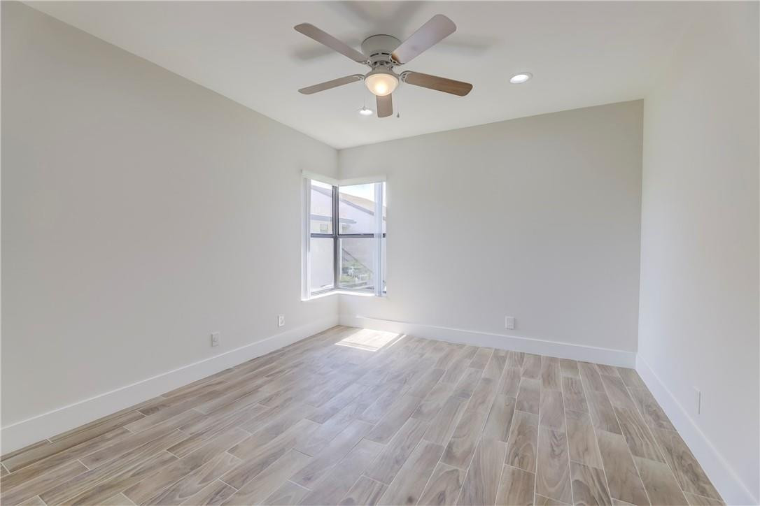 8577 Boca Glades Boulevard, Unit H Boca Raton, FL 33434 - Photo 22 of 34 an empty room with wooden floor and windows