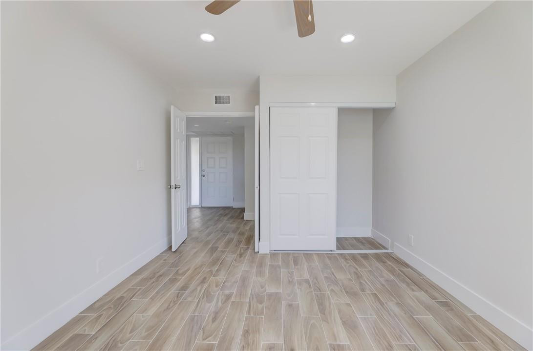 8577 Boca Glades Boulevard, Unit H Boca Raton, FL 33434 - Photo 23 of 34 a view of a room with wooden floor and a ceiling fan