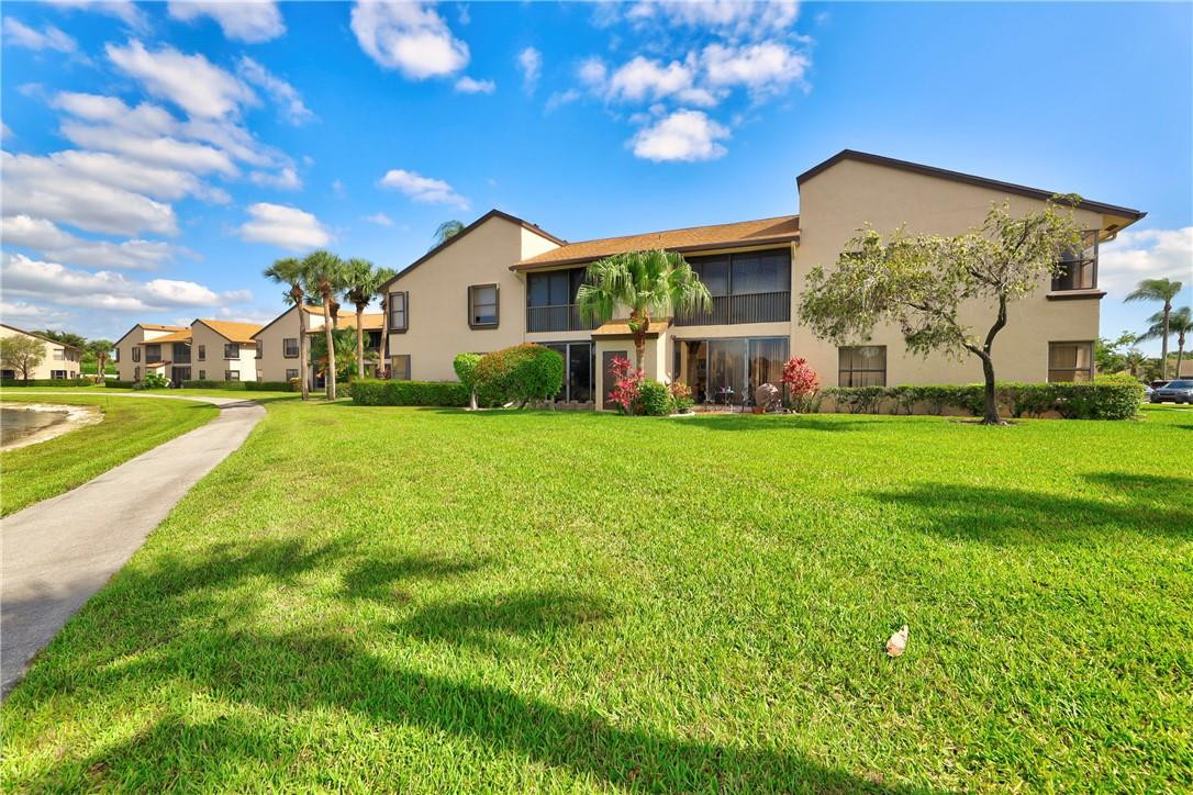 8577 Boca Glades Boulevard, Unit H Boca Raton, FL 33434 - Photo 32 of 34 a view of a house with a big yard