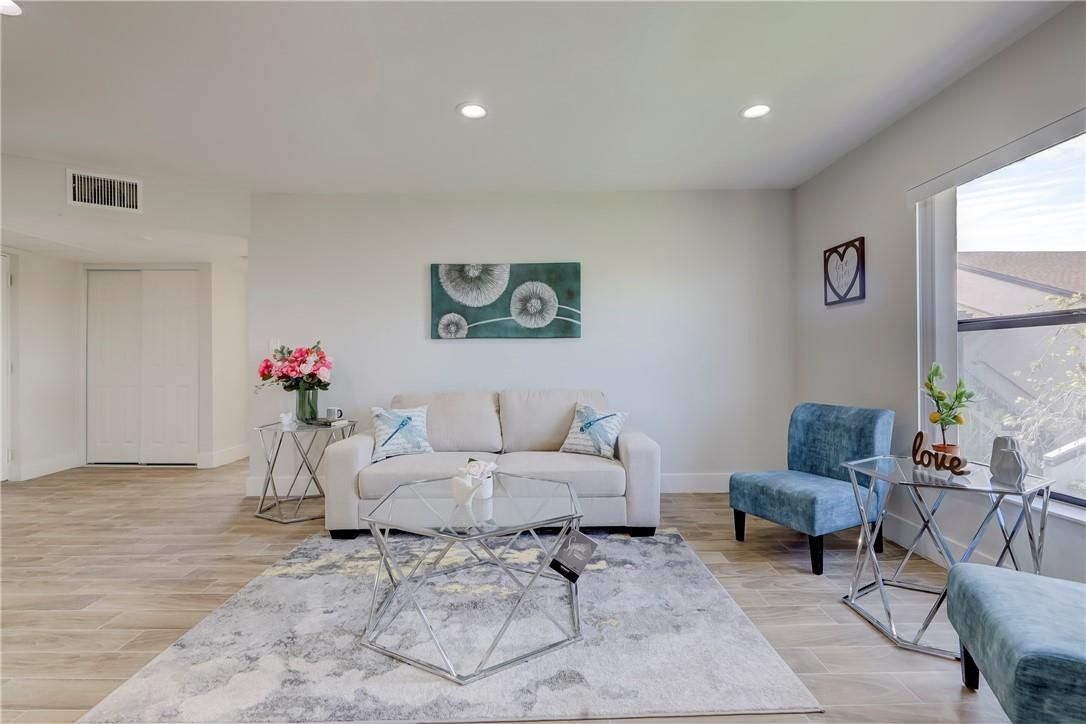 8577 Boca Glades Boulevard, Unit H Boca Raton, FL 33434 - Photo 4 of 34 a living room with furniture and flowers