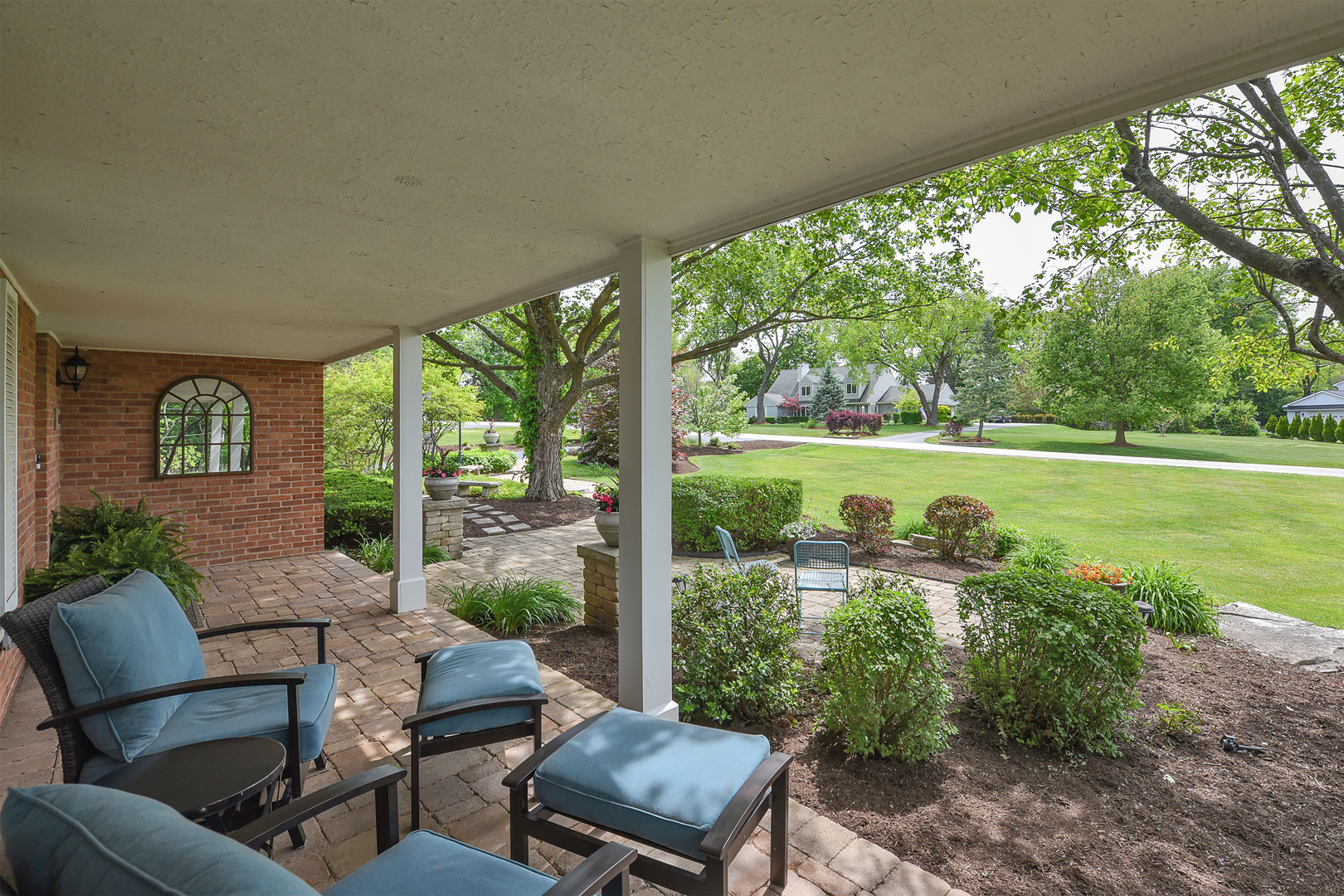 1550 Banbury Road Inverness, IL 60067 - Photo 26 of 32 a view of a patio with lawn chairs floor to ceiling window and yard