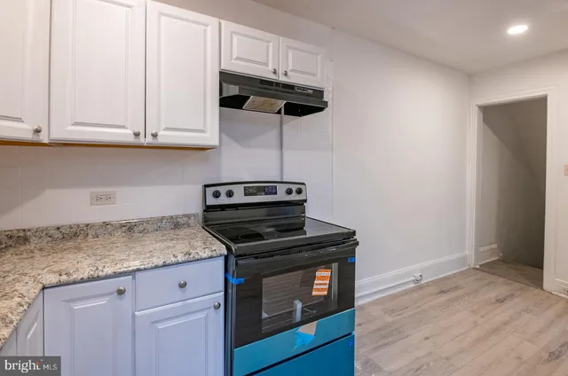 a kitchen with granite countertop cabinets and steel stainless steel appliances