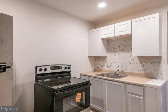 a kitchen with a sink cabinets and appliances