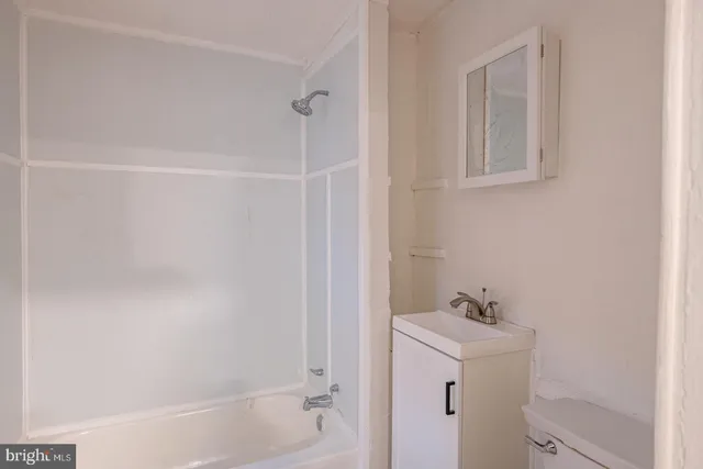 a bathroom with a bathtub sink and vanity