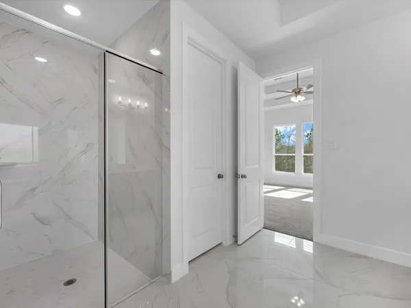 a bathroom with a glass shower door and a sink