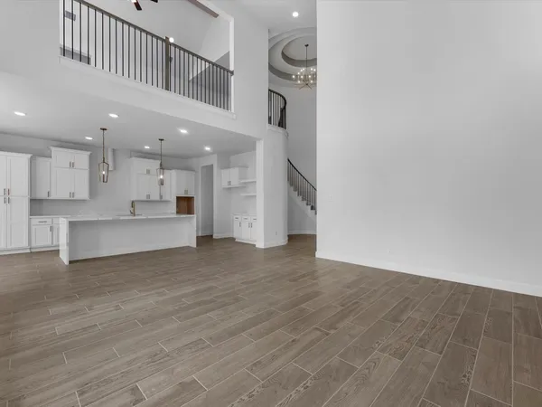 a view of kitchen with kitchen island wooden floor and center island
