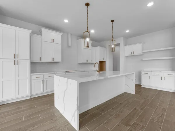 a kitchen with kitchen island a sink stainless steel appliances and cabinets