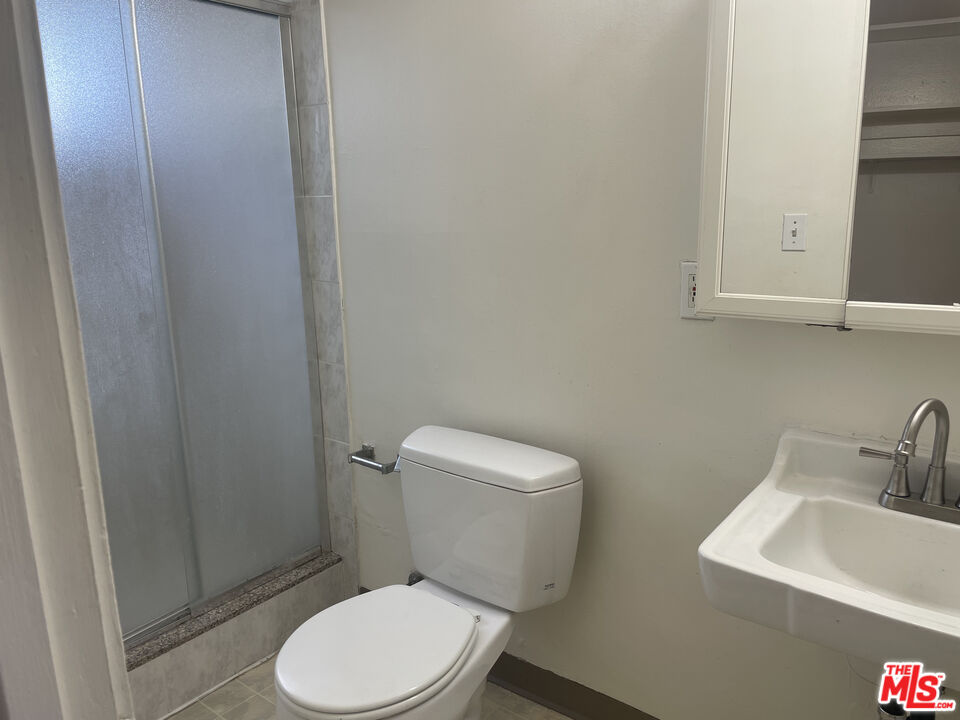 1150 North Commonwealth Avenue, Unit 2 Los Angeles, CA 90029 - Photo 7 of 8 a white toilet sitting next to a bathroom sink