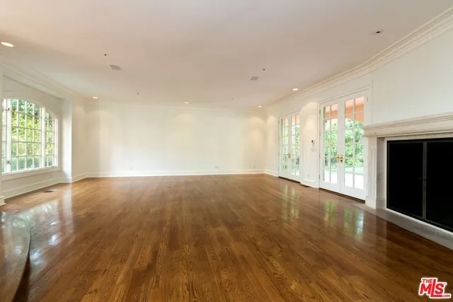a view of porch with a floor to ceiling window and wooden floor