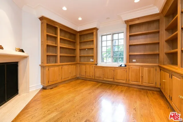 a view of an empty room with a fireplace and a window