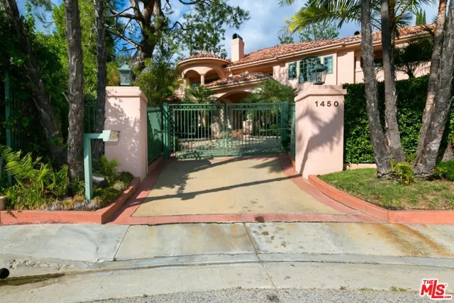 a view of a house with a yard and pathway