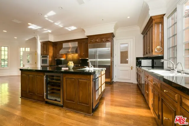 a kitchen with stainless steel appliances granite countertop a sink and a microwave