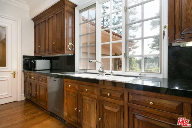 a kitchen with stainless steel appliances granite countertop a refrigerator and cabinets