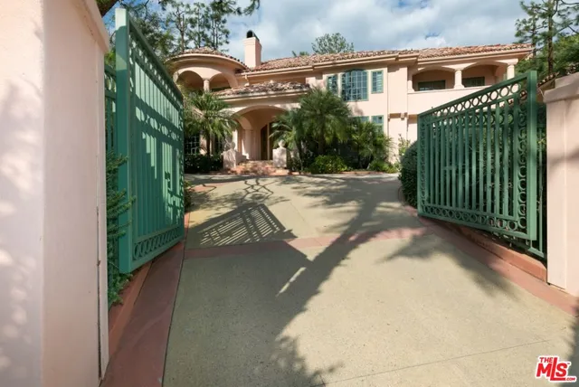 a view of a house with a small yard and potted plants