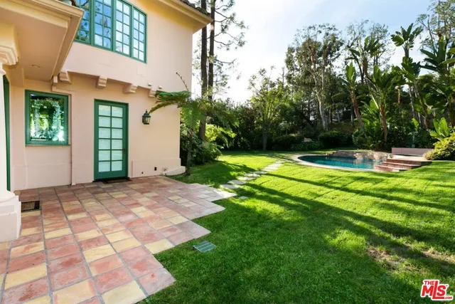 a view of a swimming pool with a yard