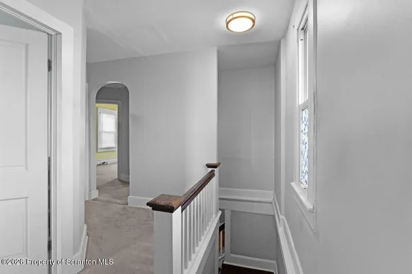 a view of an empty room and a window