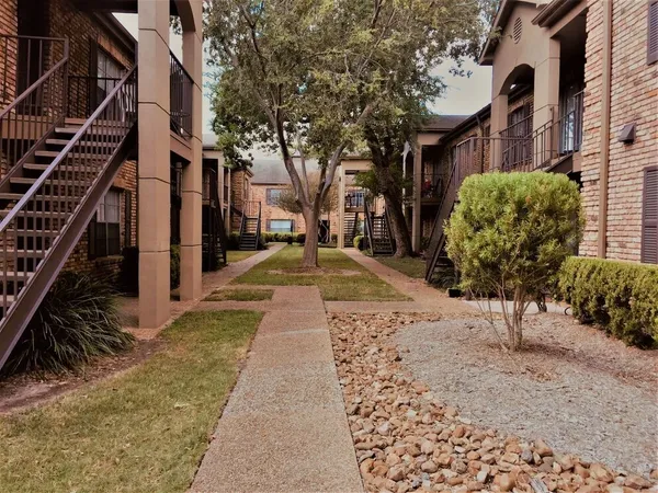 a view of a pathway with a buildings in the background