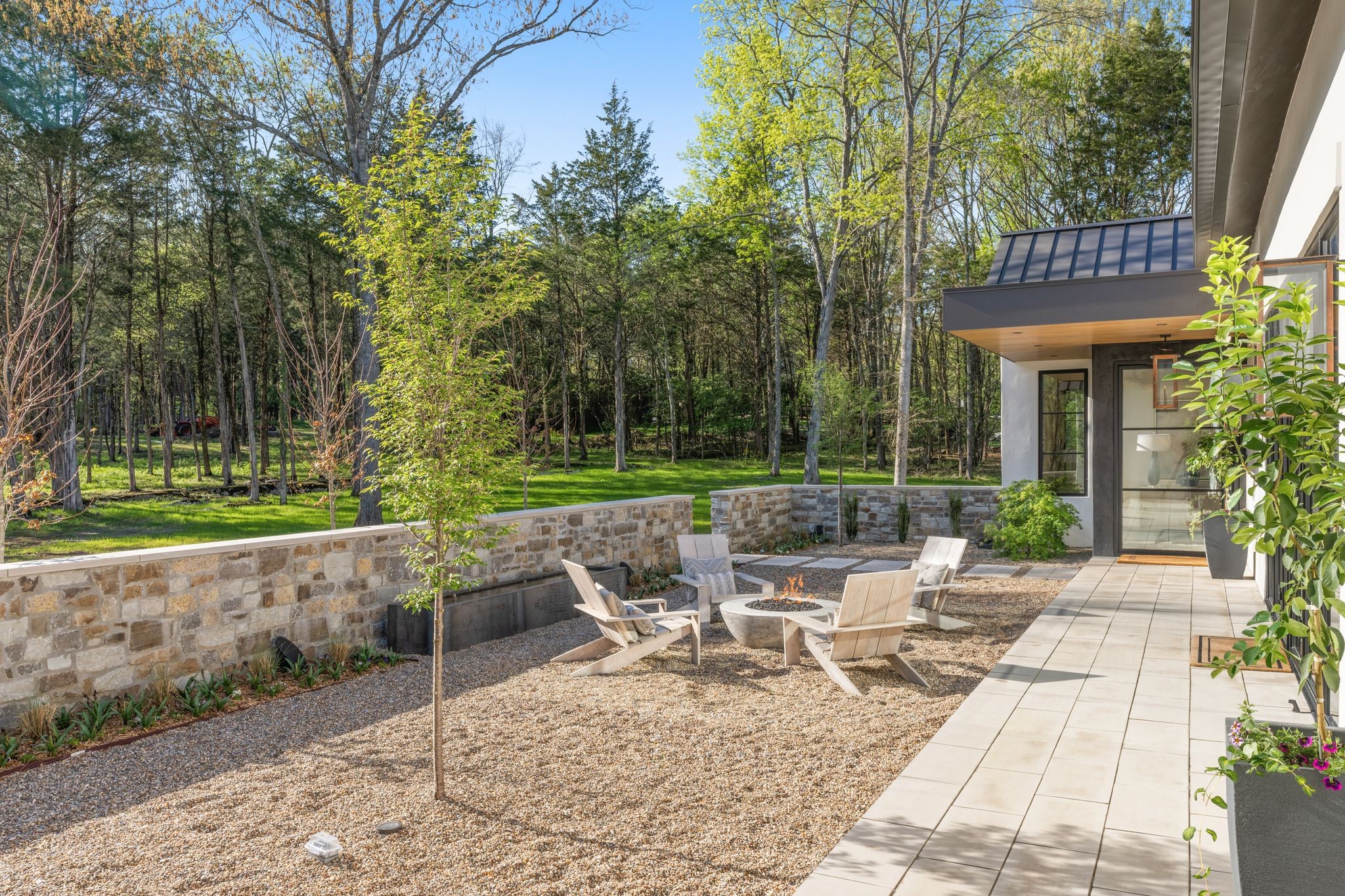 8520 Saundersville Road Mount Juliet, TN 37122 - Photo 3 of 70 a view of a patio with table and chairs potted plants and a large tree