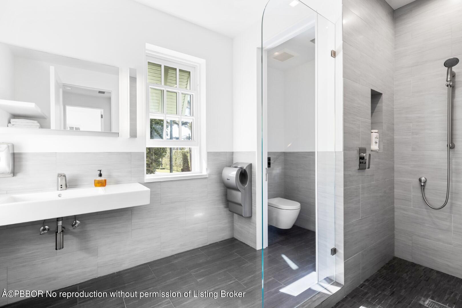 710 South County Road Palm Beach, FL 33480 - Photo 61 of 69 a bathroom with a granite countertop toilet and a sink