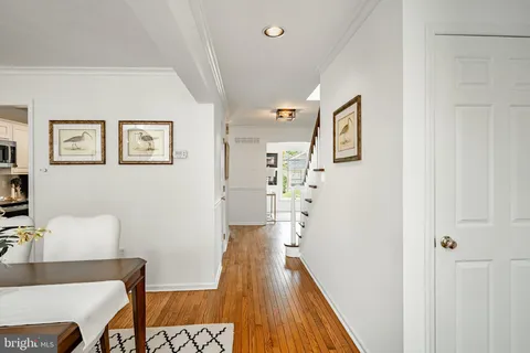 a view of a hallway with furniture and wooden floor