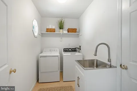 a view of storage and utility room with washer and dryer