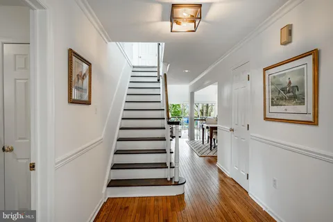a view of entryway and hall with wooden floor