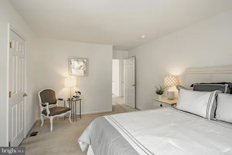 a bedroom with a bed and a chair