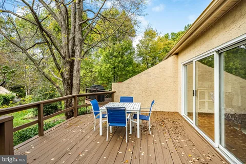 a view of a deck with table and chairs and wooden floor