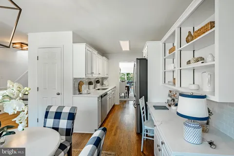 a kitchen with kitchen island a appliances dining table and chairs