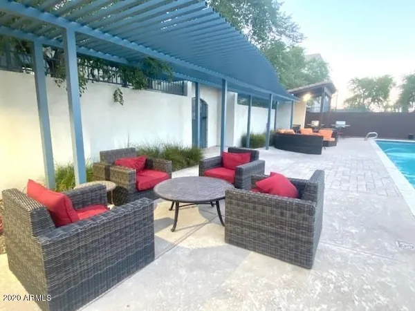 a outdoor space with the couches and dining table with the balcony