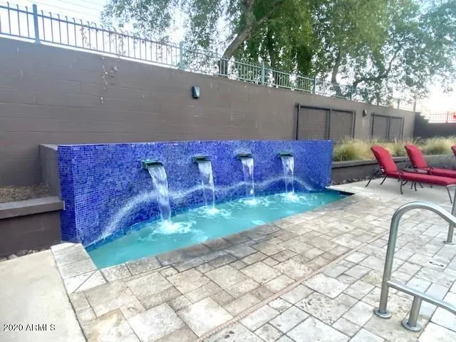 a view of backyard with tub and trees in the background