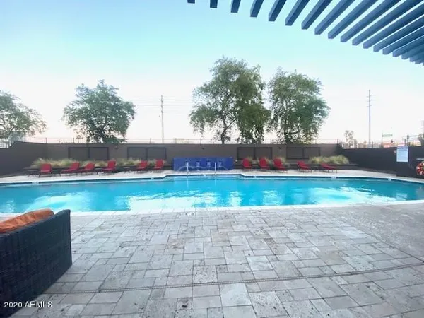 a view of swimming pool with a yard and plants