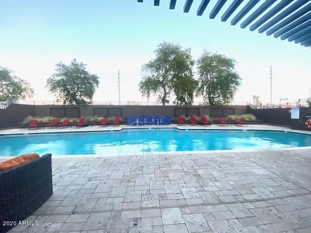 a view of swimming pool with a yard and plants