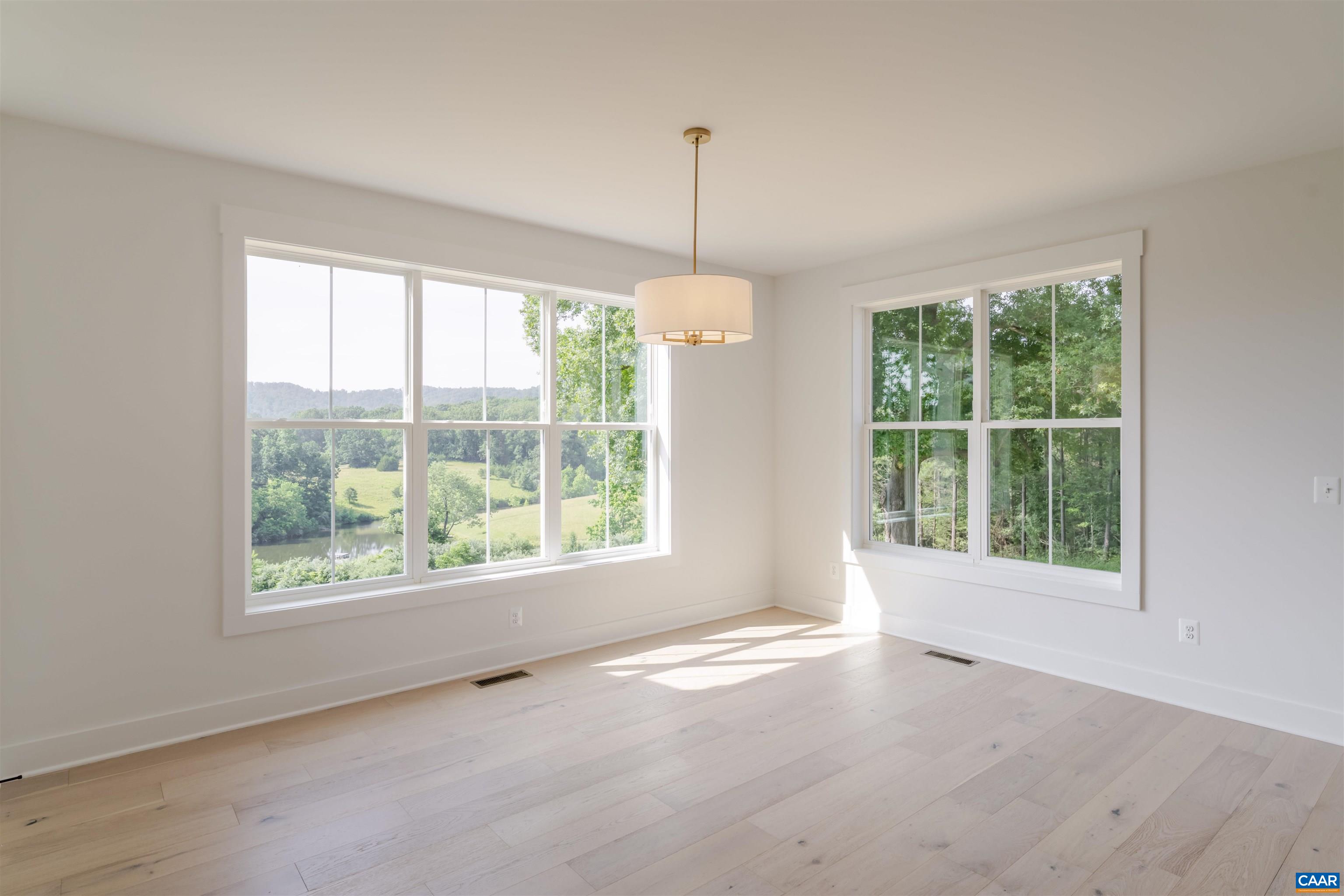 0 Free Union Road Charlottesville, VA 22901 - Photo 14 of 22 a view of an empty room with windows and chandelier fan