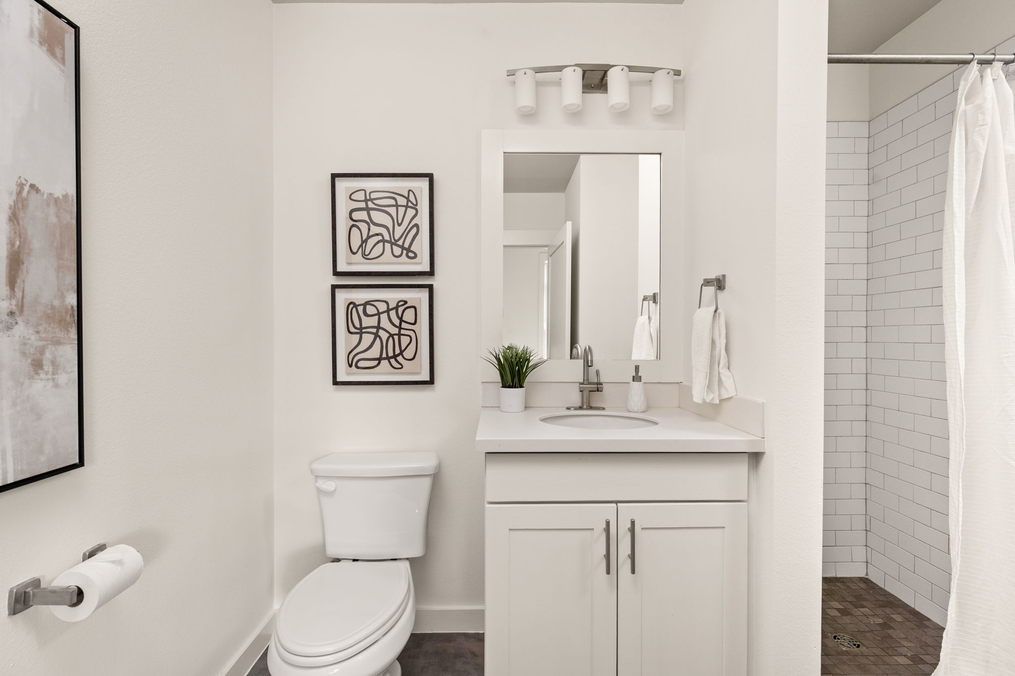 1301 Chicon Street, Unit 203 Austin, TX 78702 - Photo 11 of 27 a bathroom with a toilet sink and mirror